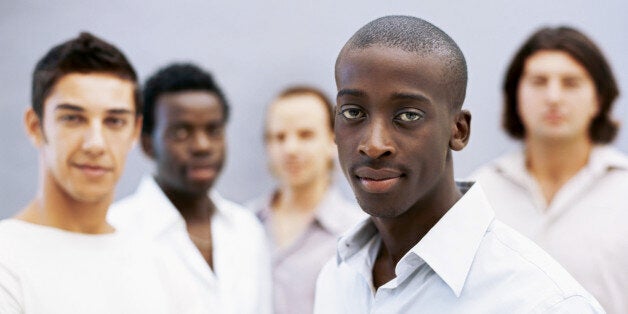 portrait of five young men standing together