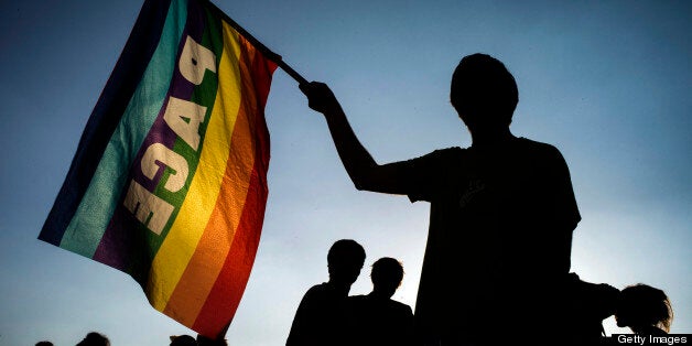 Supporters of same sex marriage demonstrate on April 23, 2013 in Lyon, southeastern France, some hours after the French National Assembly adopted a bill legalizing same-sex marriages and adoptions for gay couples, defying months of opposition protests. In its second and final reading, a majority of lawmakers approved the bill by a vote of 331 to 225. AFP PHOTO / JEFF PACHOUD (Photo credit should read JEFF PACHOUD/AFP/Getty Images)