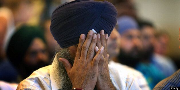 OAK CREEK, WI - AUGUST 06: A member of the Miwaukee area Sikh community weeps as he listens to information about the shooting spree of Wade Michael Page August 6, 2012 in Oak Creek, Wisconsin. Page opened fire with a 9mm pistol at the Sikh Temple of Wisconsin killing six people before being killed by police in a shootout. (Photo by Scott Olson/Getty Images)