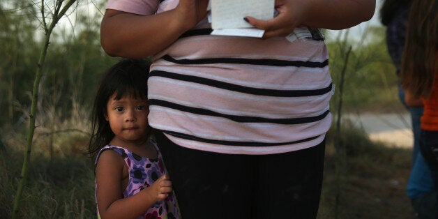 MISSION, TX - JULY 24: Honduran undocumented immigrant Laura Fabio, 2 waits for her mother after they crossed the Rio Grande illegally into the United States on July 24, 2014 in Mission, Texas. Like most of the recent surge of Central American immigrant women and children, they brought documents, often birth certificates, to prove their nationality to U.S. Border officials. Tens of thousands of immigrant families and unaccompanied minors have crossed illegally into the United States this year and presented themselves to federal agents, causing a humanitarian crisis on the U.S.-Mexico border. Texas' Rio Grande Valley has become the epicenter of the latest immigrant crisis, as more immigrants, especially Central Americans, cross illegally from Mexico into that sector than any other stretch of the America's 1,933 mile border with Mexico. (Photo by John Moore/Getty Images)