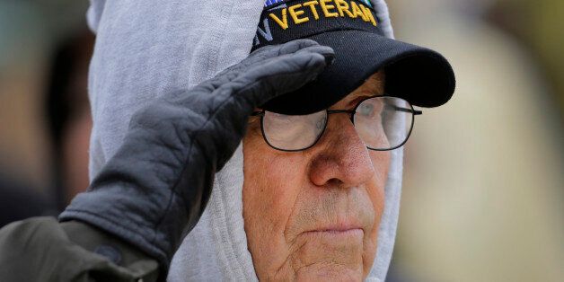 Navy veteran Jimmy Hutcherson salutes during a Veteran's Day ceremony at Fort Sam Houston National Cemetery, Tuesday, Nov. 11, 2014, in San Antonio. (AP Photo/Eric Gay)