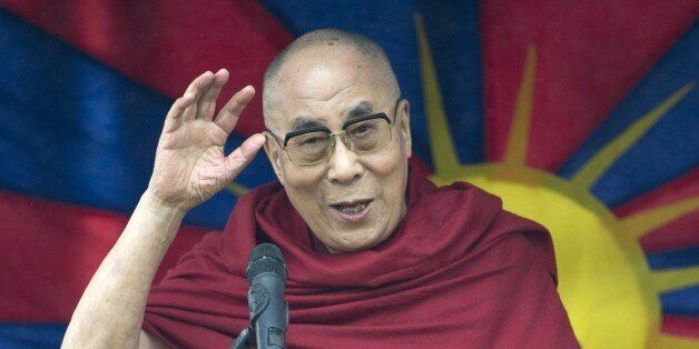 The Dalai Lama addresses an audience near the Stone Circle as he visits the Glastonbury Festival of Music and Performing Arts on Worthy Farm near the village of Pilton in Somerset, South West England on June 28, 2015. AFP PHOTO / OLI SCARFF (Photo credit should read OLI SCARFF/AFP/Getty Images)