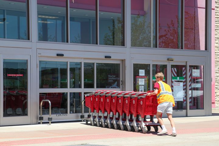 Economists are forecasting what could be the strongest year for the economy in growth led by strong consumer spending. A Target employee returns shopping carts to a store in rural Pennsylvania.