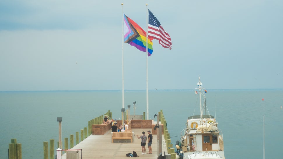 The Progress Pride Flag Raising Ceremony, part of Fire Island's inaugural Juneteenth programming, at Cherry Grove, Fire Island, New York, on June 19. The flag points to the right (representing forward progress), and sits on the left (symbolizing how there is still work to be done).