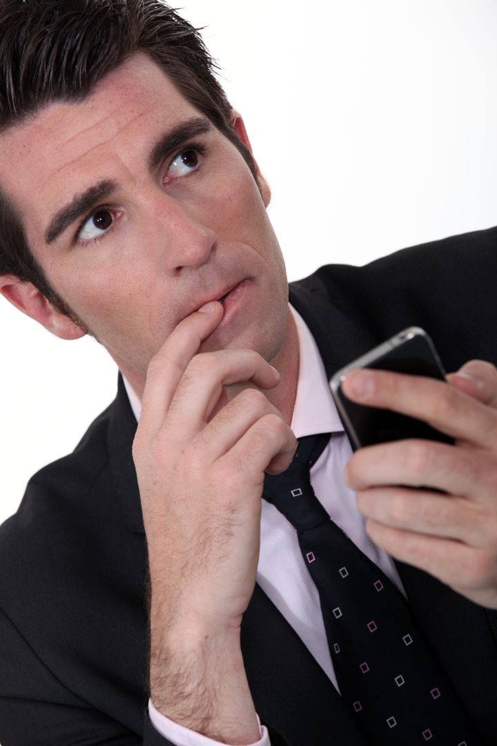 anxious businessman with mobile ...