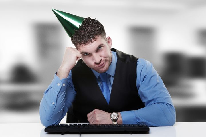 businessman wearing a party hat ...
