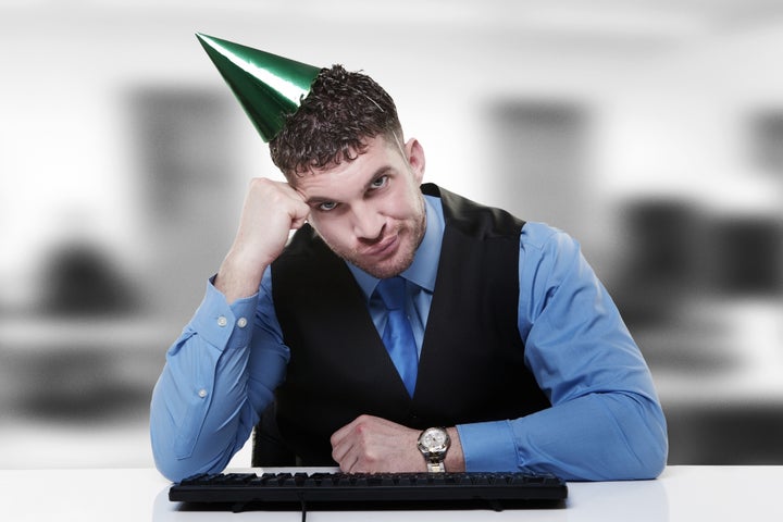 businessman wearing a party hat ...