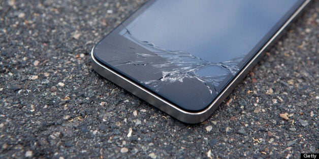 Detail of a smart phone with a cracked screen