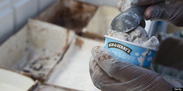 An employee of Ben & Jerry's scoops ice cream into a cone outside Union Station in Washington on June 18, 2013. AFP PHOTO / Saul LOEB (Photo credit should read SAUL LOEB/AFP/Getty Images)