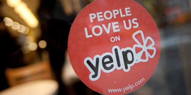 The Yelp Inc. logo is displayed in the window of a restaurant in New York, U.S., on Thursday, March 1, 2012. Yelp Inc., the site that lets users review everything from diners to dentists, is set to price it's IPO tonight and could potentially raise as much as $100 million, which would value the company at about $838 million. Photographer: Scott Eells/Bloomberg via Getty Images