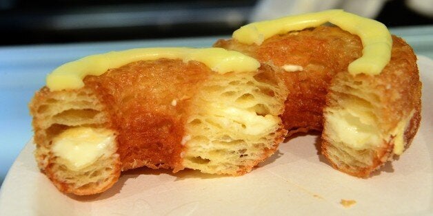 A cronut, a croissant-doughnut hybrid, the brain child of French pastry chef Dominique Ansel, sit on a plate at Ansel's bakery shop in New York on June 14, 2013. Customers line up for hours before Ansel's shop opens in the morning to have a chance to buy two cronuts per person out of the 200 cronuts Ansel produces daily. The part flaky croissant, part cream-filled doughnut, the cronut, was introduced in mid-May and is retailing at 5 USD a piece. AFP PHOTO/Emmanuel Dunand (Photo credit should read EMMANUEL DUNAND/AFP/Getty Images)