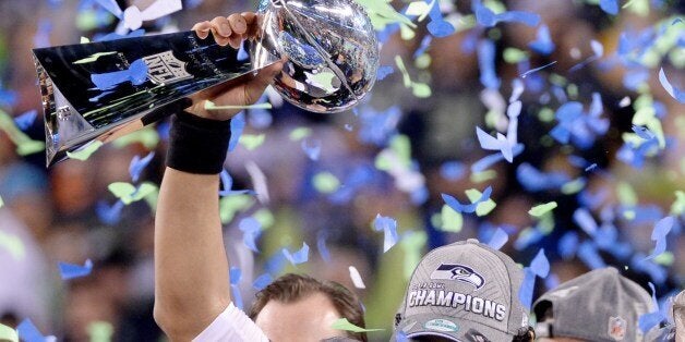 Quarterback Russell Wilson of the Seattle Seahawks holds the Vince Lombardi Trophy following victory over the Denver Broncos in Super Bowl 48 at MetLife Stadium in East Rutherford, New Jersey, on February 2, 2014. Seattle's Russell Wilson threw for two touchdowns and the Seahawks' ferocious defense overwhelmed Denver's record-setting offense, forcing three turnovers on the way to a stunning 43-8 victory in Super Bowl 48. AFP PHOTO / Timothy A. CLARY (Photo credit should read TIMOTHY A. CLARY/AFP/Getty Images)