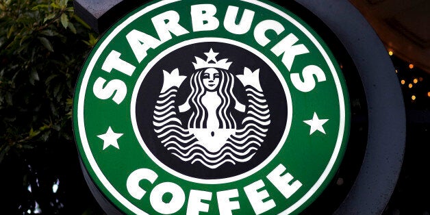 Starbucks Corp. signage hangs outside of a Starbucks coffee shop in San Francisco, California, U.S., on Tuesday, Jan. 25, 201