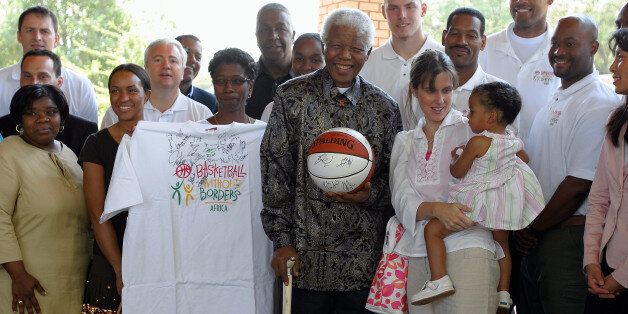 JOHANNESBURG, SOUTH AFRICA - SEPTEMBER 12: Members of the NBA Basketball Without Borders Group visits Nelson Mandela (C) during Day 6 of the 'Basketball Without Borders' African camp on September 12, 2005 at the Nelson Mandela Foundation in Johannesburg, South Africa. NOTE TO USER: User expressly acknowledges and agrees that, by downloading and/or using this photograph, User is consenting to the terms and conditions of Getty Images License Agreement. Mandatory Copyright Notice: Copyright 2005 NBAE (Photo by Catherine Steenkeste/NBAE via Getty Images)
