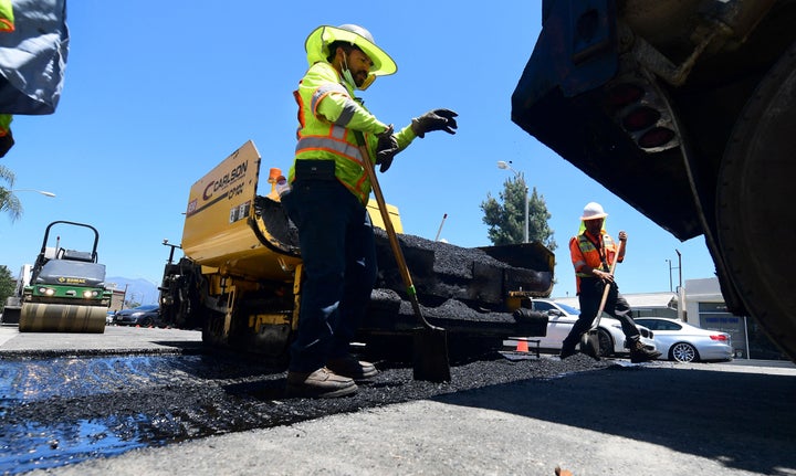 A crew works on road resurfacing on June 24 in Alhambra, California.