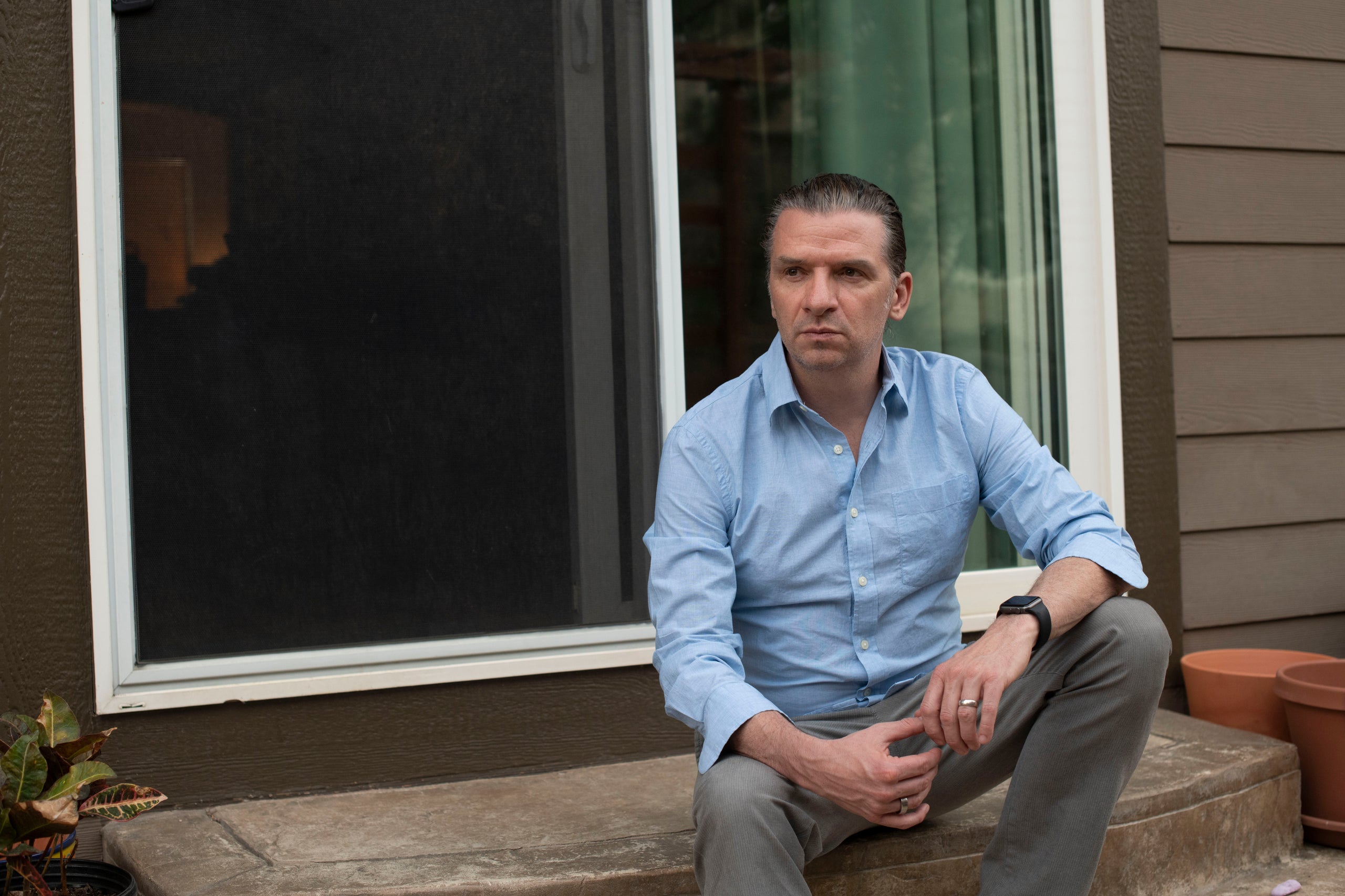 Matt McNeil, president and clinical director at LiftAffect and commercial airline pilot, poses in his yard on Wednesday, June