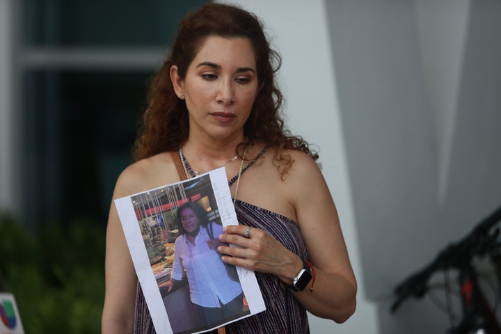 Luz Marina holds a picture of her aunt, Marina Azen, who was missing after the partial collapse of the 12-story Champlain Tow