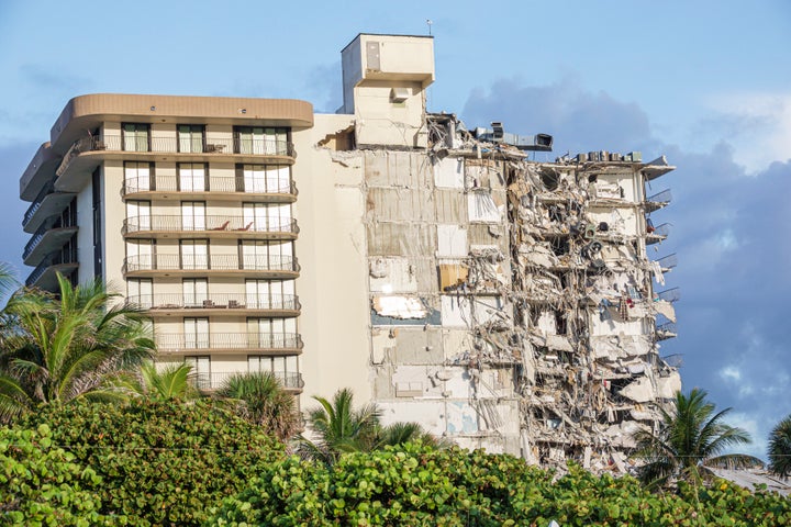 Scores of rescuers used big machines, small buckets, drones, microphones and their own hands on Friday to pick through the mountain of debris that had been the 12-story Champlain Towers South.