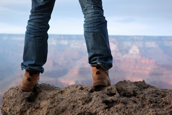 man in hiking boots standing on ...