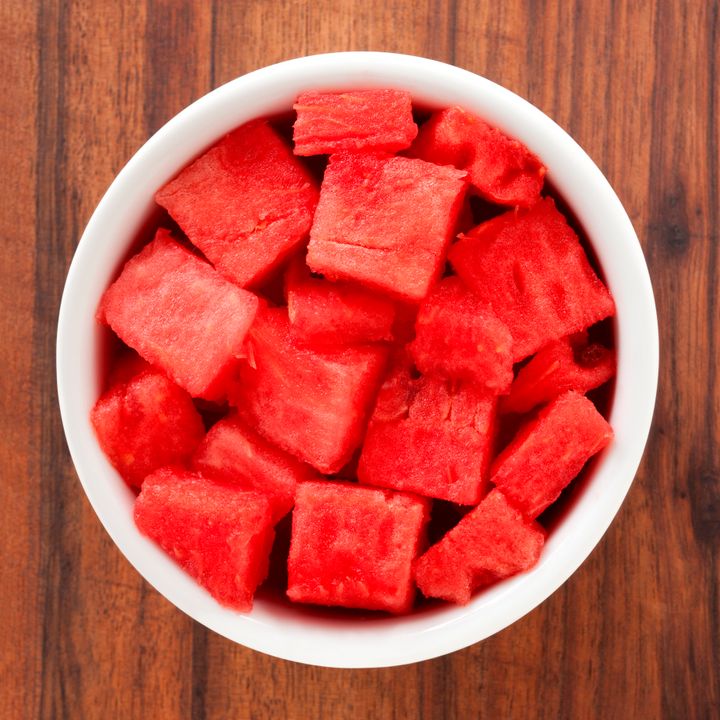 Top view of white bowl full of diced watermelon