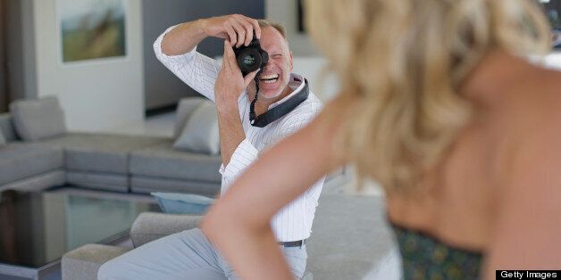 Man taking photograph of wife