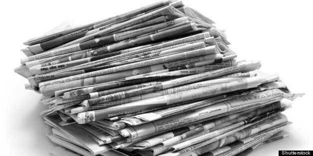 Pile of old newspapers isolated on a white background