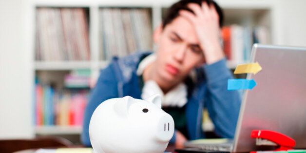 Piggy bank with young man worrying in background