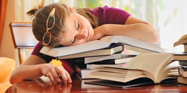 teenager girl sleeping on books