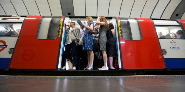 Commuters stand aboard a London Underground train before departing from Brixton station in London, U.K., on Tuesday, Aug. 6, 2013. Bank of England governor Mark Carney will present a review tomorrow on implementing forward guidance in the U.K. as improving economic data boosts the future cost of money. Photographer: Simon Dawson/Bloomberg via Getty Images