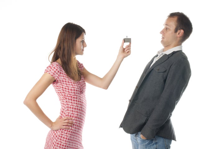 Proposal scene with happy woman and sad man.