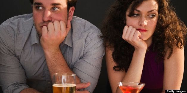 USA, New Jersey, Jersey City, Bored couple sitting at bar counter