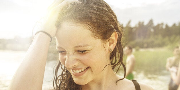 Teenage girl having fun at quarry pond