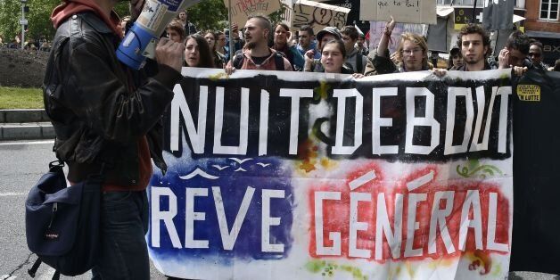 Protesters hold a banner reading 'Nuit debout (Up all Night movement) general dream' (a play of words with General strike) during a demonstration against proposed government labour and employment law reforms on May 19, 2016 in Toulouse, southern France. France was disrupted by a third straight day of strikes and demonstrations on May 19 as the prime minister called for protesters who torched a police car to face 'harsh' punishment. The labour reforms have sparked two months of protests on France's streets. / AFP / PASCAL PAVANI (Photo credit should read PASCAL PAVANI/AFP/Getty Images)