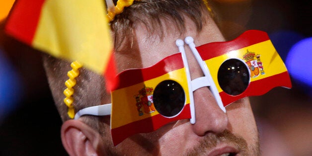 A follower of Spain's acting Primer Minister and candidate of Popular Party Mariano Rajoy, celebrates the results of the party at the national elections in Madrid, Spain, Sunday, June 26, 2016. Spain's Interior Ministry says 92 percent of the votes have been officially counted in the country's repeat election and the conservative Popular Party leads with 32 percent of the vote. (AP Photo/Paul White)