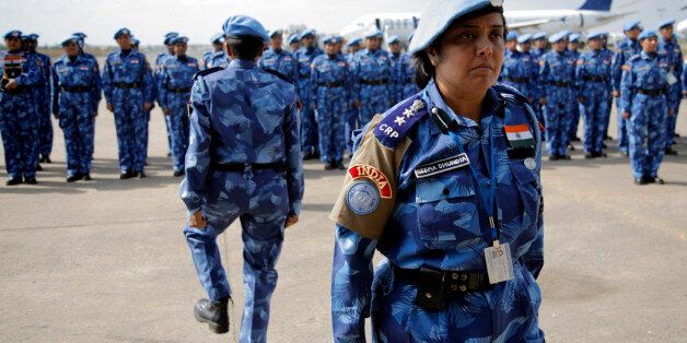 The first all-female unit of United Nations peacekeepers stand at attention as they arrive at Roberts International Airport outside Liberia's capital Monrovia January 30, 2007. The group of more than 100 police women from India will stay in Liberia for six months, helping to train the local police force. REUTERS/Christopher Herwig (LIBERIA)
