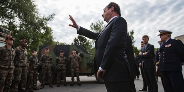 France's President Francois Hollande waves to soldiers of the anti-terror Vigipirate plan, dubbed 'Operation Sentinelle' at the fort of Vincennes, on the outskirts of Paris, on July 25, 2016. French President Francois Hollande met troops mobilised for anti-terror operation 'Sentinelle' on July 25, promising to increase financial measures for military purposes during the state of emergency. / AFP / POOL / IAN LANGSDON (Photo credit should read IAN LANGSDON/AFP/Getty Images)