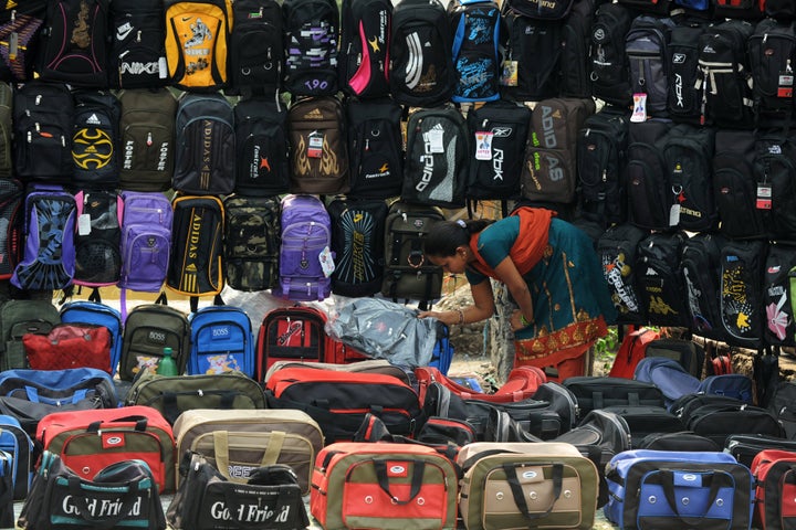 An Indian roadside vendor arranges bags for sale in Siliguri on March 22, 2013. India's government said the economy will likely register its slowest annual growth in a decade and expand just five percent in the fiscal year ending in March, citing official estimates released in February. AFP PHOTO/Diptendu DUTTA (Photo credit should read DIPTENDU DUTTA/AFP/Getty Images)