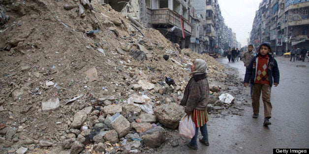 ALEPPO, SY - FEBRUARY 13: A Syrian girl pauses in awe of the destruction wrought by an Assad regime bombing run on a busy street in Aleppo, the country's largest city and economic capital. (Paul Watson/Toronto Star via Getty Images)