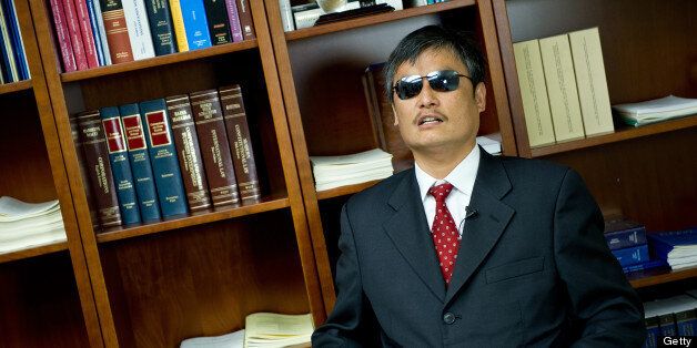 Chen Guangcheng, Chinese human rights activist, during an interview with AFP April 9, 2013 in Washington, DC. Chen, the most public foe of China's forced abortion policy, will speak before the US House Committee on Foreign Affairs Subcommittee on Africa, Global Health, Global Human Rights later April 9. The hearing, 'Chen Guangcheng and Gao Zhisheng: Human Rights in China,' will focus on Beijing's dismal record of human rights abuses, something many politicians said would improve if the nation were granted permanent most favored nation trading status in 2001. AFP PHOTO/Karen BLEIER (Photo credit should read KAREN BLEIER/AFP/Getty Images)
