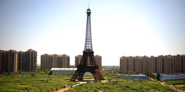 This picture taken on August 7, 2013 shows a replica of the Effel Tower in Tianducheng, a luxury real estate development located in Hangzhou, east China's Zhejiang province. China's ability to reproduce foreign products is best known for imitation luxury purses and copies of Hollywood films. But knockoffs have ranged from a three-dollar version of Kate Middleton's engagement ring to fake Apple stores and an entire Austrian village. CHINA OUT AFP PHOTO (Photo credit should read STR/AFP/Getty Images)