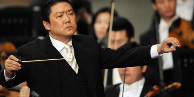 Music director of China Philharmonic Orchestra Long Yu is pictured during a concert for Pope Benedict XVI at Paul VI hall in Vatican City on May 7, 2008. Pope Benedict XVI described the Beijing Olympic Games as 'an event of great importance for the entire human family' as he received the China Philharmonic at the Vatican today. It was the pontiff's first remarks on the upcoming Olympiad, which have been the target of global controversy since unrest broke out in Tibet in March, prompting a crackdown by the Communist Party regime in Beijing. AFP PHOTO/ Tiziana Fabi (Photo credit should read TIZIANA FABI/AFP/Getty Images)