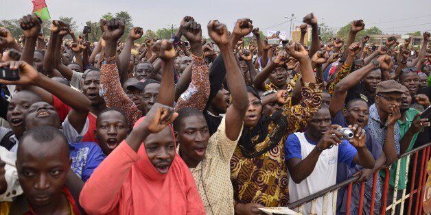 Burkinese opposition supporters shout slogans during a protest at Nation Square in Ouagadougou on January 18, 2014. Burkina Faso's opposition leader Zephirin Diabre has called for protests against plans by President Blaise Compaore to extend his mandate by another five years. AFP PHOTO/AHMED OUOBA (Photo credit should read AHMED OUOBA/AFP/Getty Images)
