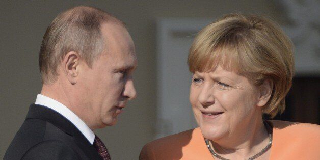 Russias President Vladimir Putin (L) welcomes Germanys Chancellor Angela Merkel at the start of the G20 summit on September 5, 2013 in Saint Petersburg. Russia hosts the G20 summit hoping to push forward an agenda to stimulate growth but with world leaders distracted by divisions on the prospect of US-led military action in Syria. AFP PHOTO / ALEXANDER NEMENOV (Photo credit should read ALEXANDER NEMENOV/AFP/Getty Images)