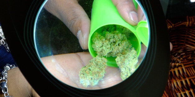 An employee displays recreational marijuana inside the Evergreen Apothecary in Denver, Colorado, U.S., on Thursday, Jan. 9, 2014. Colorado has just legalized the commercial production, sale, and recreational use of marijuana, while Washington State will begin its own pot liberalization initiative at the end of February. On Jan. 8, New York Governor Andrew Cuomo said his state would join 20 others and the District of Columbia in allowing the drug for medical purposes. Photographer: Matthew Staver/Bloomberg via Getty Images