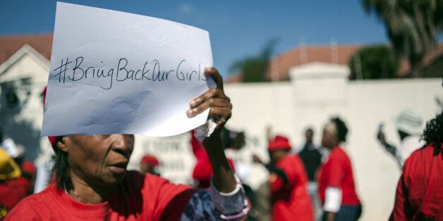 PRETORIA, SOUTH AFRICA - MAY 19: A group gathering out front of the Nigeria High Commission hold a demonstration for 200 schoolgirls abducted by Boko Haram the terrorist group last month. On April 14, Boko Haram militants stormed a school in Chibok, located on the fringes of the Sambisa Forest, and forced scores of schoolgirls onto trucks before driving away. (Photo by Ihsaan Haffejee/Anadolu Agency/Getty Images)