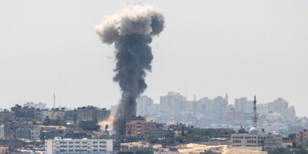 A picture taken from the southern Israeli Gaza border shows smoke billowing from buildings following an Israeli air strike in Gaza City, on July 10, 2014. The United Arab Emirates pledged $25 million in humanitarian aid to 'support the steadfastness' of Palestinians in Gaza where Israeli strikes have killed more than 70 people in three days. AFP PHOTO / JACK GUEZ (Photo credit should read JACK GUEZ/AFP/Getty Images)
