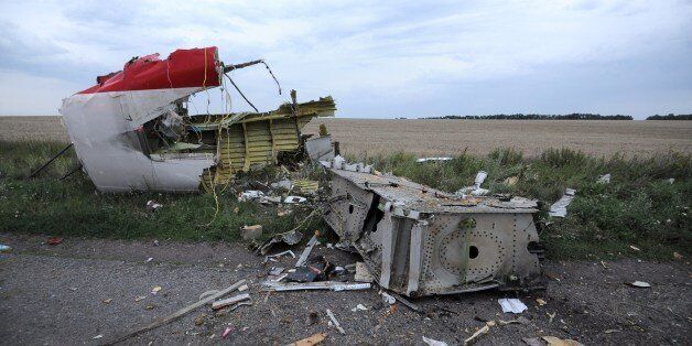 A picture taken on July 17, 2014 shows the wreckages of the malaysian airliner carrying 295 people from Amsterdam to Kuala Lumpur after it crashed, near the town of Shaktarsk, in rebel-held east Ukraine. Pro-Russian rebels fighting central Kiev authorities claimed on Thursday that the Malaysian airline that crashed in Ukraine had been shot down by a Ukrainian jet. The head of Ukraine's air traffic control agency said Thursday that the crew of the Malaysia Airlines jet that crashed in the separatist east had reported no problems during flight. AFP PHOTO/DOMINIQUE FAGET (Photo credit should read DOMINIQUE FAGET/AFP/Getty Images)