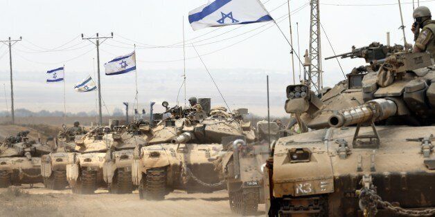Israeli Merkava tanks roll near the border between Israel and the Gaza Strip as they return from the Hamas-controlled Palestinian coastal enclave on August 5, 2014, after Israel announced that all of its troops had withdrawn from Gaza. Israel completed the withdrawal of all troops from Gaza as a 72-hour humanitarian truce went into effect following intense global pressure to end the bloody conflict. AFP PHOTO / THOMAS COEX (Photo credit should read THOMAS COEX/AFP/Getty Images)