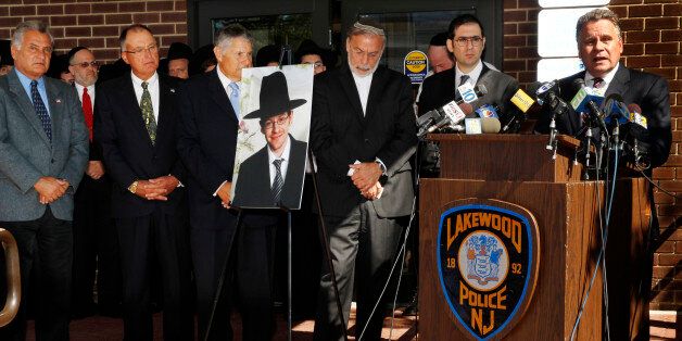 U.S. Rep. Chris Smith, right, R-NJ, addresses a gathering as he stands near a photograph of Aaron Sofer, center, 23, Tuesday, Aug. 26, 2014, in Lakewood, N.J. Israeli police said Tuesday they are searching for the young New Jersey religious student who went missing in Israel during a hike in a forest outside Jerusalem last week. Sofer of Lakewood, New Jersey, has been missing since Friday when he went on a hike with a friend in the Jerusalem Forest, said police spokesman Micky Rosenfeld. (AP Photo/Mel Evans)