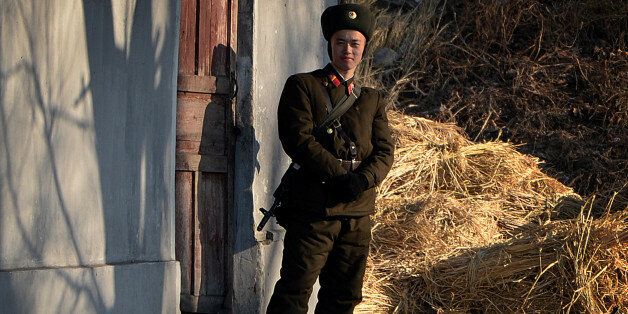 A North Korea soldier stands guard on the banks of the Yalu River which separates the North Korean town of Sinuiju from the Chinese border town of Dandong on December 16, 2013. China has lost its key North Korean interlocutor with the purging of Kim Jong-Un's uncle, but analysts say the young leader's tightening grip on power may be welcomed by Beijing, which prizes stability in its wayward nuclear-armed ally. AFP PHOTO/Mark RALSTON (Photo credit should read MARK RALSTON/AFP/Getty Images)